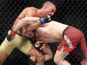 Khabib Nurmagomedov, right, fights Edson Barboza in a lightweight mixed martial arts bout at UFC 219, Saturday, Dec. 30, 2017, in Las Vegas. (AP Photo/John Locher)
