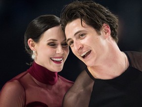 Tessa Virtue, left, and Scott Moir skate off the ice after performing their free dance during the senior ice dance competition at the Canadian Figure Skating Championships in Vancouver on Jan. 13, 2018