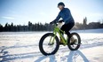 Tom Babin tries out the Surface 604 electric pedal-assist fat bike in Calgary, thanks to bike shop Power in Motion. (Leah Hennel/Postmedia)