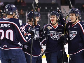 Tri-City Americans defenceman Jake Bean celebrates with teammates after his first period goal against the Calgary Hitmen at the Saddledome on Wednesday night.