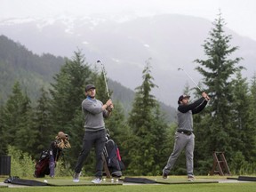 Bobsled athletes Chris Spring, right, and Justin Kripps hit shots at the Fairmont driving range in Whistler, B.C., on June 8, 2016. Spring and Kripps took up golf as part of their training program.