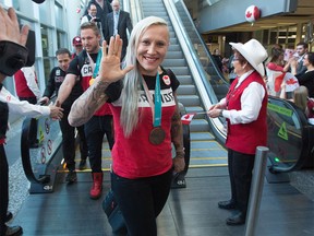 Canada's Kaillie Humphries wears her Olympic bronze medal in bobsleigh as she greets fans after arriving with other Canadian Olympic athletes in Calgary on Monday, Feb. 26, 2018.