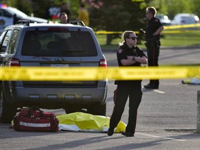 Calgary police attend the scene of a double-fatal shooting on Sunday, May 21, 2017.