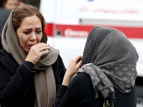 Relatives of Iranian passengers, on board the Aseman Airlines flight EP3704, react as they gather in front of a mosque near Tehran's Mehrabad airport on Feb. 18, 2018. (ATTA KENARE/AFP/Getty Images)