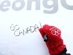 A well wisher is the first to sign a public message board near downtown Calgary on Thursday, February 8, 2018  The City of Calgary and East Village has put up the board to wish Canadaís Olympic athletes good luck and best wishes while they compete in Korea. Jim Wells/Postmedia