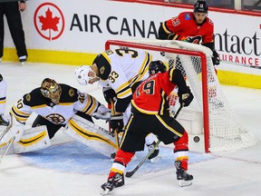 Calgary Flames Matthew Tkachuk scores on Tuukka Rask of the Boston Bruins during NHL hockey at the Scotiabank Saddledome in Calgary on Monday, February 19, 2018. Al Charest/Postmedia