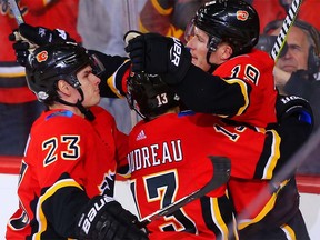 Calgary Flames Matthew Tkachuk celebrates with teammates Sean Monahan and Johnny Gaudreau after scoring against the Boston Bruins in NHL hockey at the Scotiabank Saddledome in Calgary on Monday, February 19, 2018. Al Charest/Postmedia