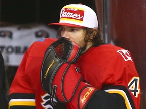 Flames goalie Mike Smith sits on the bench after being pulled in the third period during game action between the Tampa Bay Lightning and the Calgary Flames in Calgary on Thursday, February 1, 2018.