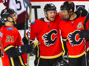 Calgary Flames Troy Brouwer celebrates with teammates after scoring against the Colorado Avalanche in NHL hockey at the Scotiabank Saddledome in Calgary on Saturday, February 24, 2018.