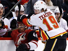 Calgary Flames left-winger Matthew Tkachuk (right) checks Arizona Coyotes left-winger Jordan Martinook during the first period of an NHL hockey game Thursday, Feb. 22, 2018, in Glendale, Ariz.