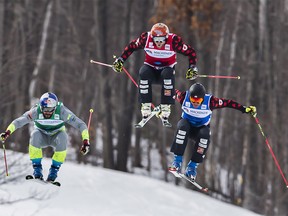 Brady Leman of Canada, centre, races to a gold medal win in front of his compatriot and silver medal winner Christopher Del Bosco, right, as Filip Flisar is a Slovenia follows for bronze during the FIS Ski Cross World Cup 2017 in The Blue Mountains, Ont., Sunday, March 5, 2017. THE CANADIAN PRESS/Mark Blinch ORG XMIT: MDB109