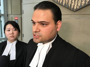 Shamsher Kothari, counsel to John McNamara, speaks to reporters outside the Calgary Courts Centre. McNamara, who has HIV, pleaded guilty to six counts of aggravated sexual assault.