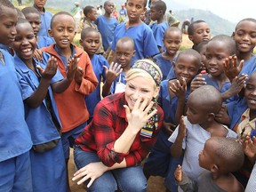 Natalya Neidhart of the WWE shares a laugh with Rwandan children.