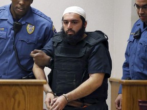 In this Dec. 20, 2016, file photo, Ahmad Khan Rahimi, center, is led into court in Elizabeth, N.J. Rahimi, who set off small bombs on a New York City street and at a charity race in New Jersey, is set to be sentenced to a mandatory term of life in prison. He is scheduled to be sentenced Tuesday, Feb. 13, 2018, by a federal judge in Manhattan.