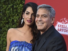 In this Oct. 22, 2017 file photo, Amal Clooney and George Clooney arrive at the premiere of "Suburbicon" in Los Angeles.