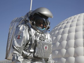 This Feb. 7, 2018, photo shows analog astronaut Kartik Kumar wearing an experimental space suit during a simulation of a future Mars mission in the Dhofar desert of southern Oman. (AP Photo/Sam McNeil)