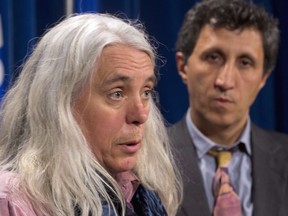 Quebec Solidaire MNA Manon Masse (left) responds to a reporter's question at the legisature in Quebec City on Thursday, May 29, 2014 as colleague Amir Khadir, right, looks on.