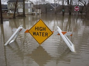 High water floods the street from the Ohio River, Saturday, Feb. 24, 2018 in Cincinnati. Forecasters expected the Ohio River could reach levels not seen since the region's deadly 1997 floods.