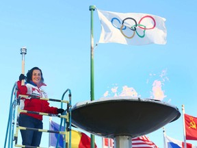 Robyn Ainsworth (Perry) lights the cauldron at Canada Olympic Park to open WinSport's celebration of the Pyeongchang Games in Calgary on Friday, Feb. 9, 2018. Ainsworth lit the torch 30 years ago at McMahon Stadium to start the 1988 Calgary Winter Olympic Games.