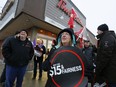 Protesters gather outside a Tim Hortons location in Peterborough, Ont. on Wednesday January 10, 2018 in response to some franchisees scaling back benefits in response to a provincial minimum wage increase.