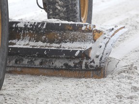 A snowplow chugs along Kensington Road.