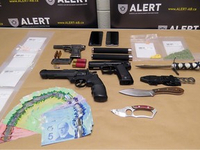 Weapons, drugs and cash were seized from a raid on a suspected drug house in Lethbridge on Feb. 26 2018. ALERT photo