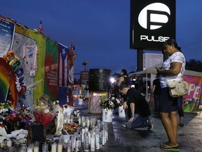 Christian Malone prays as he visits the memorial to the victims of the mass shooting setup around the Pulse gay nightclub one day before the one year anniversary of the shooting on June 11, 2017 in Orlando, Florida.