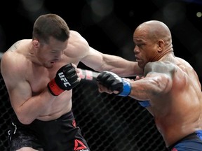 CB Dollaway (L) and Hector Lombard trade punches during their middleweight bout during UFC 222 at T-Mobile Arena on March 3, 2018 in Las Vegas, Nevada. Dollaway won by disqualification due to a late hit by Lombard.