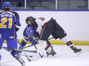 Xtreme's Jake Neighbours (right) battles for the puck with Royals' Nathanial Bierd as the Airdrie Xtreme fall 2-1 to the Calgary Royals in Alberta Major Bantam AAA Hockey League action at the Ron Ebbesen Arena on Saturday December 5, 2015 in Airdrie, Alta. Britton Ledingham/Airdrie Echo/Postmedia Network