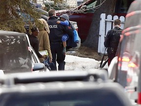 Calgary police help nearby residents leave the area where an active shooter shot a police officer in Abbeydale on Tuesday March 27, 2018. Darren Makowichuk/Postmedia