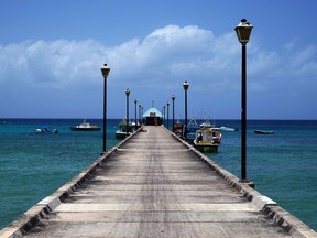 Fishing boats are docked at a jetty in Bridgetown, Barbados.