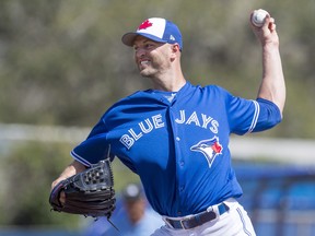 Toronto Blue Jays starting pitcher J.A. Happ pitches to the Detroit Tigers during first inning exhibition baseball action in Dunedin, Fla. on Sunday, February 25, 2018. THE CANADIAN PRESS/Frank Gunn ORG XMIT: FNG104