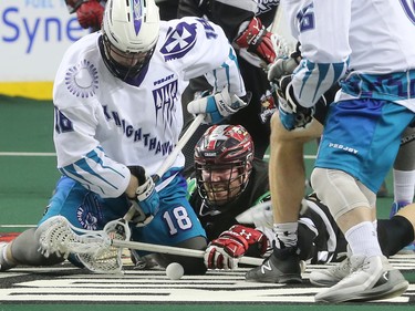 The Calgary Roughnecks Tyler Burton and Rochester Knighthawks players battle for control of the ball during NLL action at the Scotiabank Saddledome in Calgary on Saturday March 17, 2018.