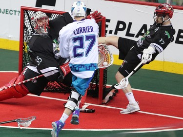 Calgary Roughnecks goaltender Christian Del Bianco and Curtis Dickson stop this scoring chance by the Rochester Knighthawks' Josh Currier during NLL action at the Scotiabank Saddledome in Calgary on Saturday March 17, 2018.