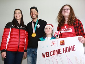 Canada's Brian McKeever poses for photos with friends, family and fans after he was welcomed home at the Calgary International Airport on Monday March 19, 2018. McKeever won 3 gold medals at the 2018 Paralympics making him Canada's most decorated winter Paralympian. Gavin Young/Postmedia