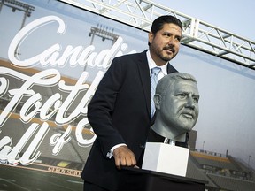 Hall of Fame inductee Anthony Calvillo poses with his bust in Hamilton on Thursday, September 14, 2017. (THE CANADIAN PRESS/Peter Power)