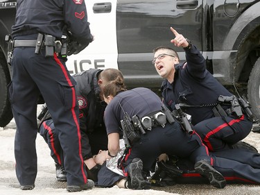 Calgary police tend to an officer shot in Abbeydale on Tuesday March 27, 2018. The officer is reportedly in stable condition in hospital.