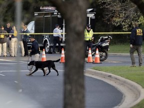 Officials work and stage near the site of Sunday's deadly explosion, Monday, March 19, 2018, in Austin, Texas.