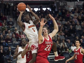 Calgary Dinos' Mambi Diawara, left, shoots over McGill Redmen's Francois Bourque during the first half of semifinal action in the USports men's basketball national championship in Halifax on Saturday, March 10, 2018. THE CANADIAN PRESS/Darren Calabrese ORG XMIT: DBC109