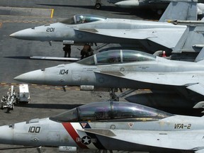 In this March 3, 2017 file photo, a row of F18 fighter jets are shown on the deck of the U.S. Navy aircraft carrier USS Carl Vinson (CVN 70) off the disputed South China Sea.