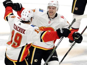 Calgary Flames left winger Matthew Tkachuk celebrates with centre Matt Stajan after Tkachuk scored the winning goal against the Nashville Predators on Oct. 24, 2017