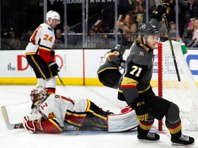 Vegas Golden Knights center William Karlsson (71) celebrates a goal past Calgary Flames goaltender Mike Smith (41) during an NHL hockey game Sunday, March 18, 2018, in Las Vegas. Flames defenseman Travis Hamonic (24) is in the background. It was Karlsson's third goal of the game.