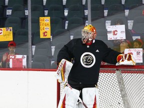 Calgary Flames goalie David Rittich is surrounded by grade four students from Mayland Heights school during Flames practice at the Saddledome in Calgary Thursday, March, 15, 2018.