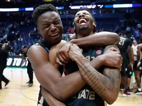 Mfiondu Kabengele of the Florida State Seminoles celebrates with Braian Angola after defeating the Xavier Musketeers in the second round of the 2018 NCAA basketball tournament at Bridgestone Arena on March 18, 2018