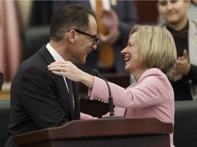 Alberta Finance Minister Joe Ceci (left) hugs Premier Rachel Notley after delivering Budget 2018 in the Alberta Legislature in Edmonton, on Thursday, March 22, 2018. Photo by Ian Kucerak/Postmedia