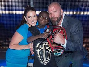 Stephanie McMahon and Triple H with Jarrius.