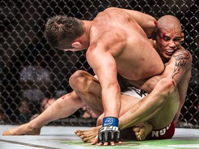 Kajan Johnson (right) holds on to Tae Hyun Bang during a UFC 174 lightweight bout at Rogers Arena in Vancouver, B.C. on Saturday, June 14, 2014. (Postmedia file photo)