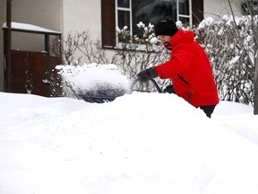 Sebastian Lindner like most Calgarians was busy shoveling snow yet again after Calgary recieved another reord amount of the white stuff on Saturday March 3, 2018. Darren Makowichuk/Postmedia