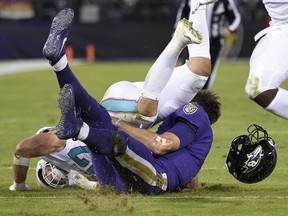 This Oct. 26, 2017 photo shows Dolphins middle linebacker Kiko Alonso, top left, colliding with Ravens quarterback Joe Flacco during NFL action in Baltimore.