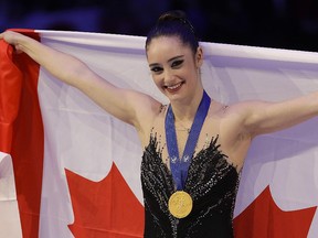 Kaetlyn Osmond of Canada celebrates after winning the gold medal at the World Championships in Assago, near Milan, Italy, Friday, March 23, 2018. (AP Photo/Luca Bruno)